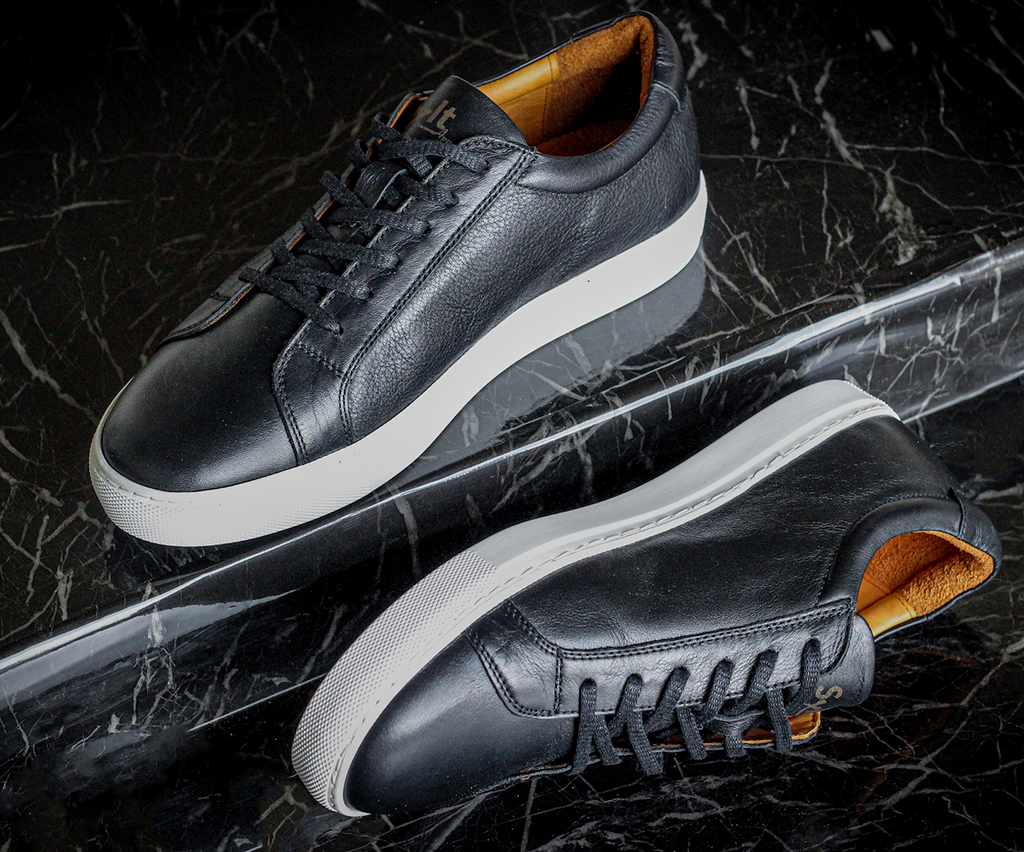 Polished leather shoes showcased against a clean background, highlighting their sleek design and fine craftsmanship